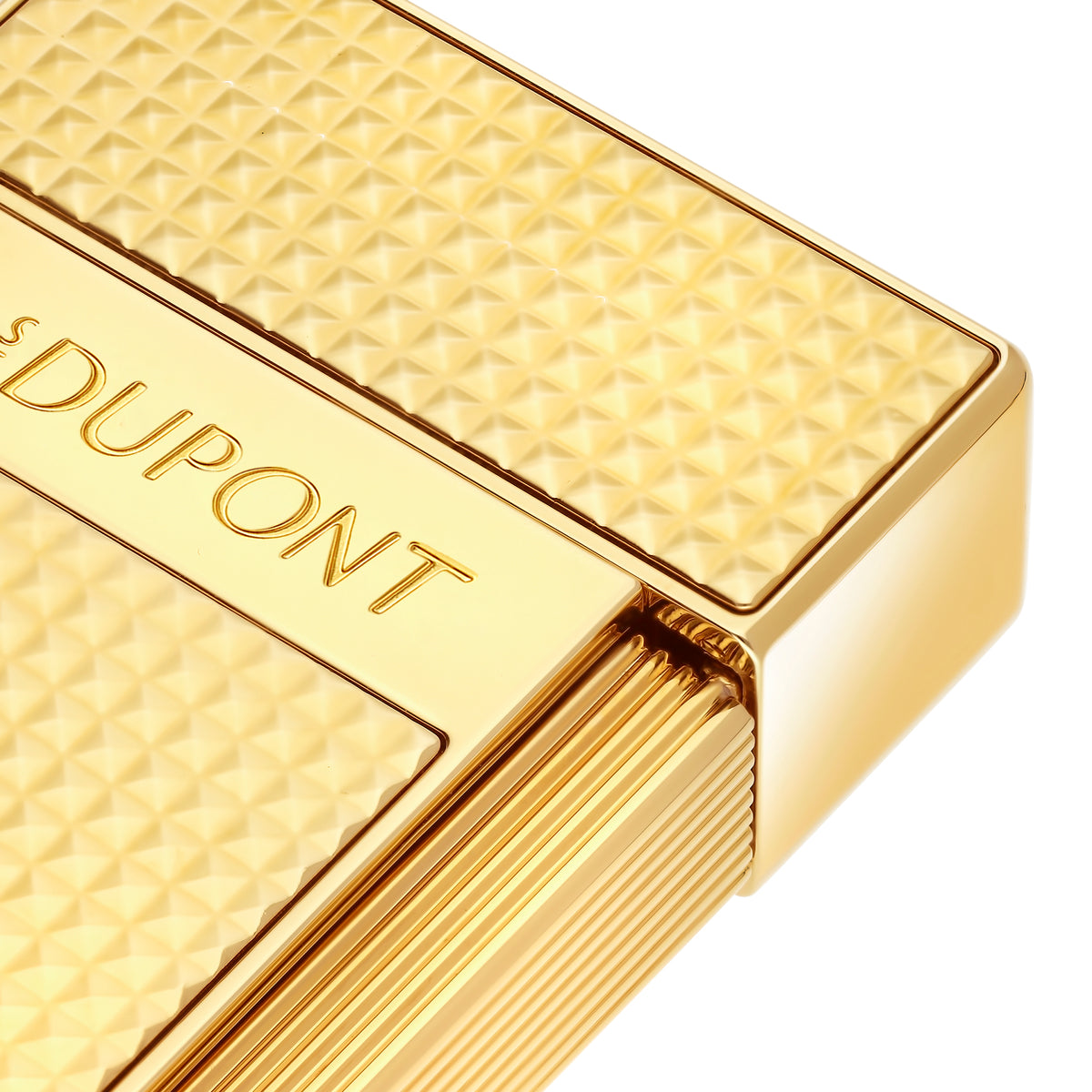Close-up of the S.T. Dupont Biggy lighter in gold, showing the Diamond Head guilloché and engraved S.T. Dupont band