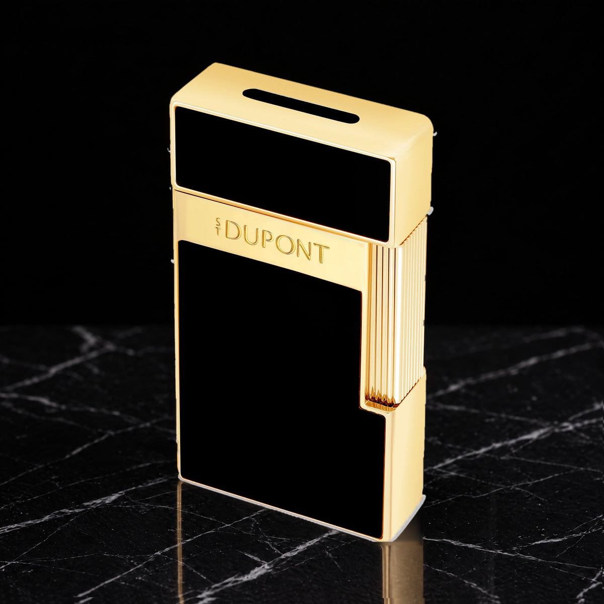 S.T. Dupont Biggy torch lighter in black lacquer with gold trim, three-quarter view, cap closed