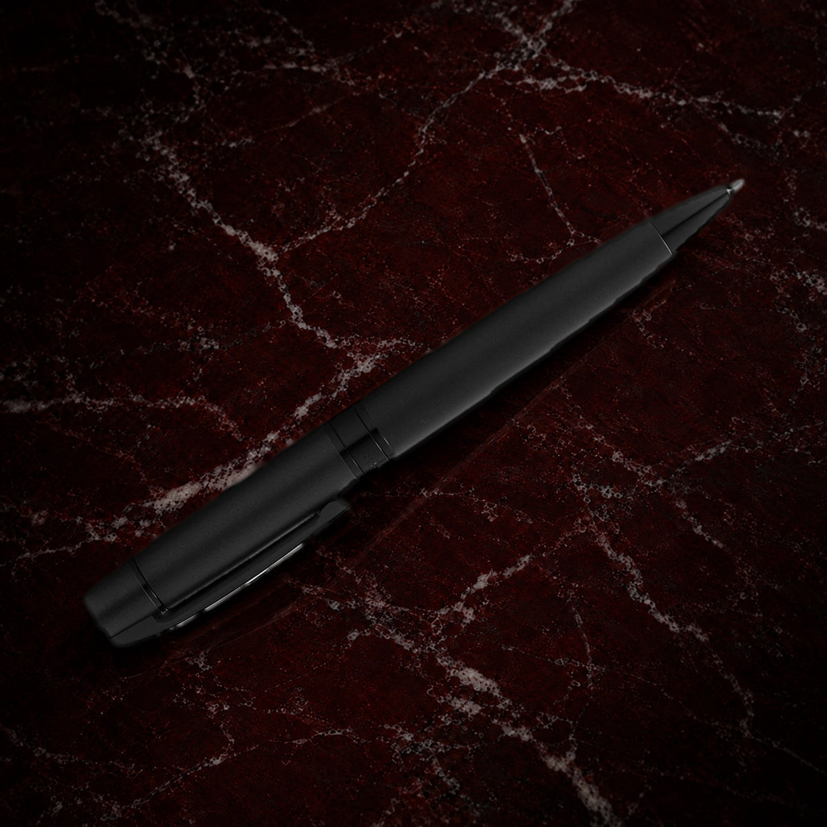 Sheaffer 300 Pen — Matte Black with Black Trim: the ballpoint in matte black lacquer with polished black trim, on garnet marble