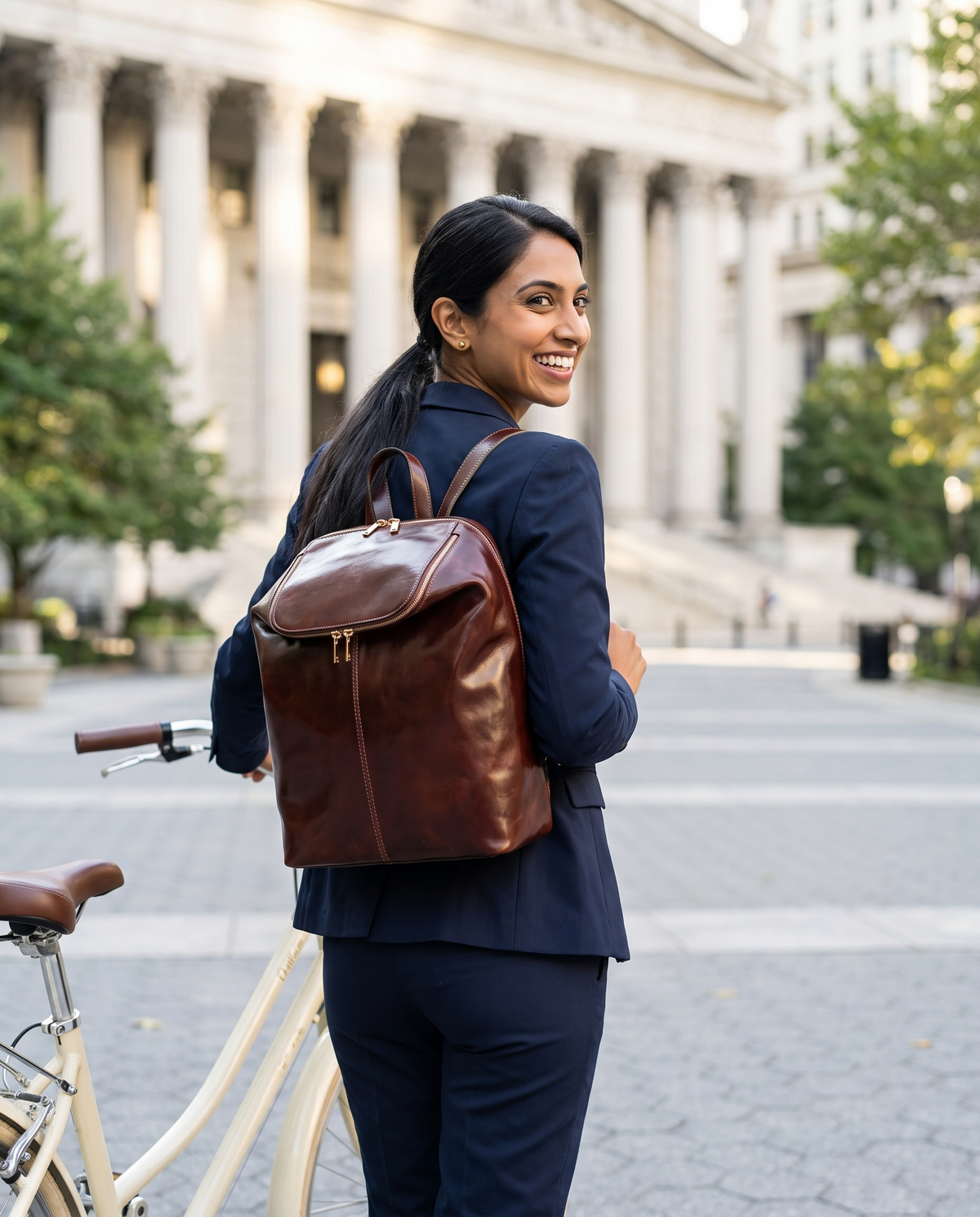 A Bend in the River — Women's Leather Backpack, worn on a bicycle commute to the courthouse
