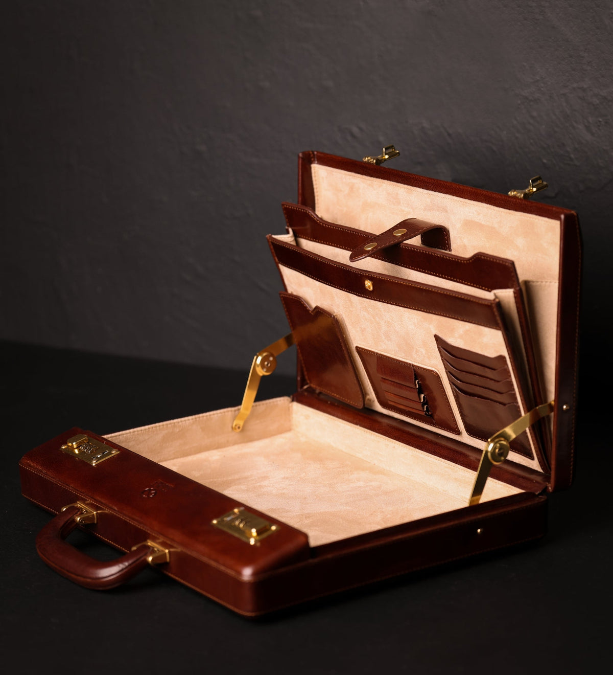 Vendetta brown leather attaché case open on its hinge, showing the lined interior, document pockets and card slots