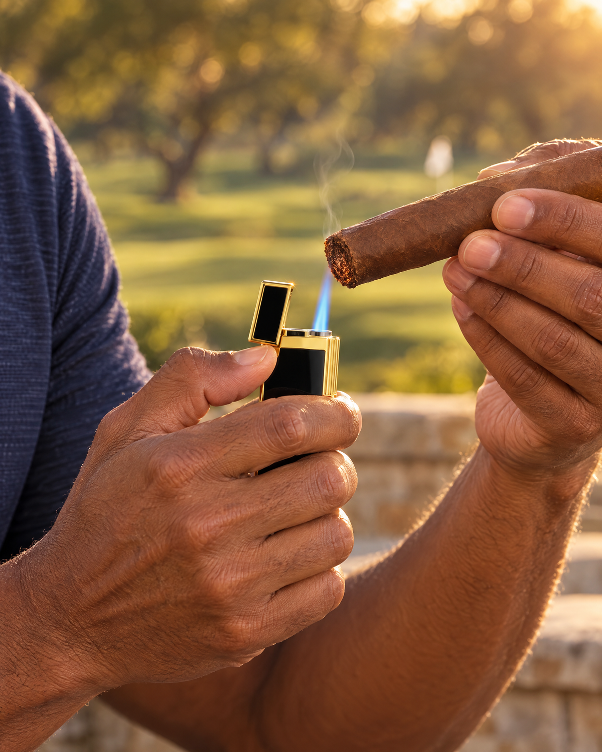 S.T. Dupont Biggy Lighter — Black Lacquer & Gold, torch flame toasting the foot of a cigar on a golf clubhouse terrace