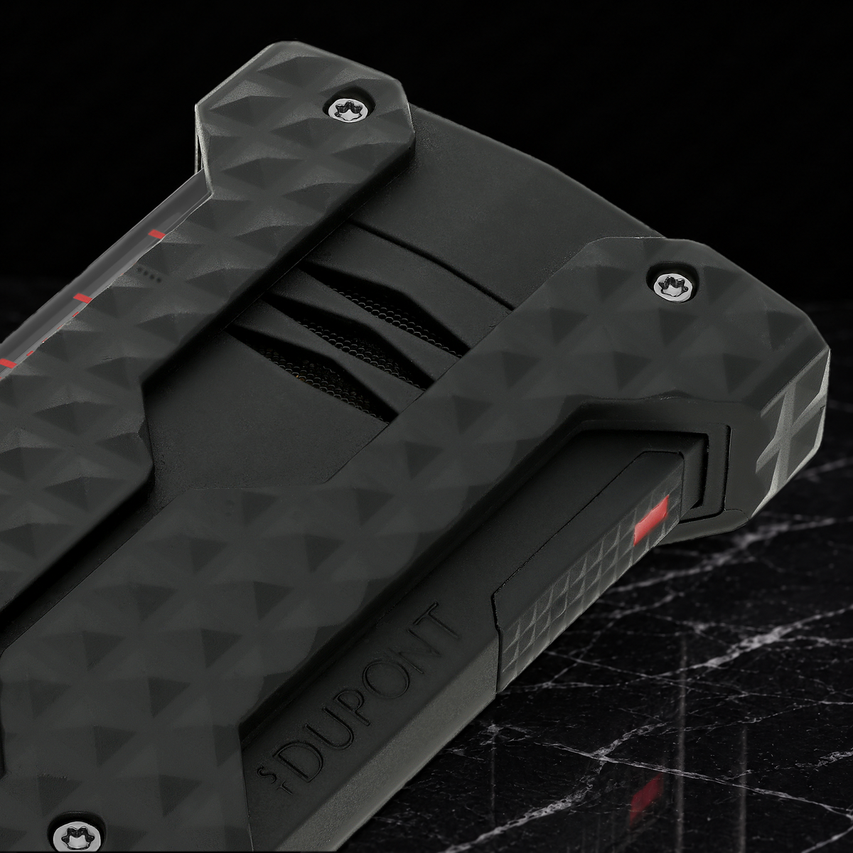 Close-up of the S.T. Dupont Windproof lighter in black, showing the recessed burner vents and corner bumpers