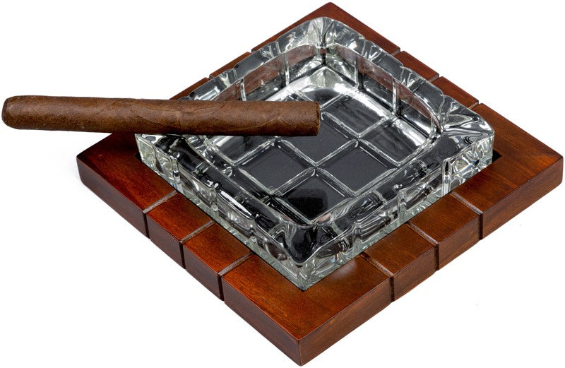 Wood and crystal cross-hatched ashtray, cigar on the rest, close angled view