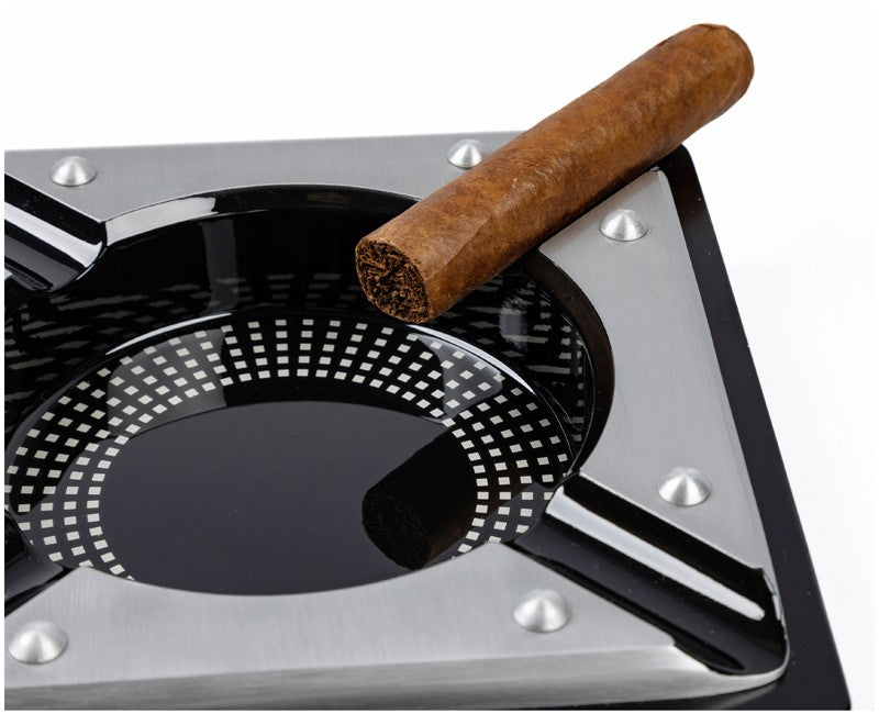 Saint Lucia metal cigar ashtray, close view of the perforated steel bowl and cigar