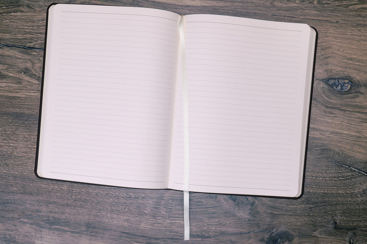 Large Leather Journal opened to ruled pages with the ribbon marker