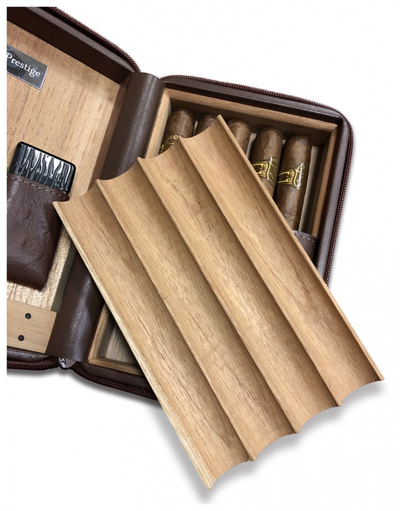 The removable four-cigar cedar bed lifting out of The Manhattan travel humidor case; cigars not included