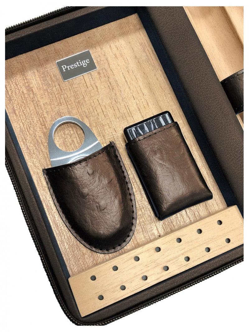 Spanish cedar interior of The Manhattan travel humidor, with the included guillotine cutter and butane torch in fitted leather sleeves