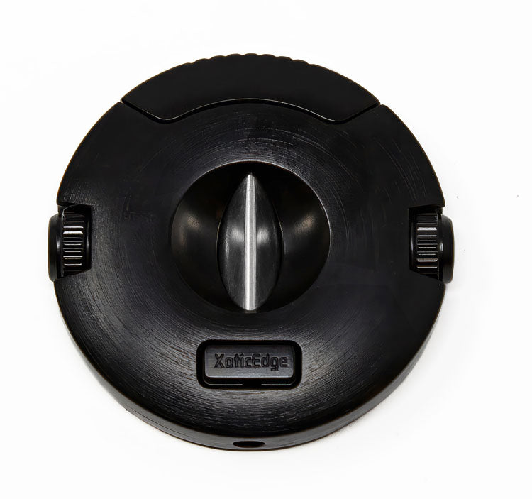 The Xceed cigar cutter closed, shown straight-on with the XoticEdge logo on the face and a screw-off punch at each side