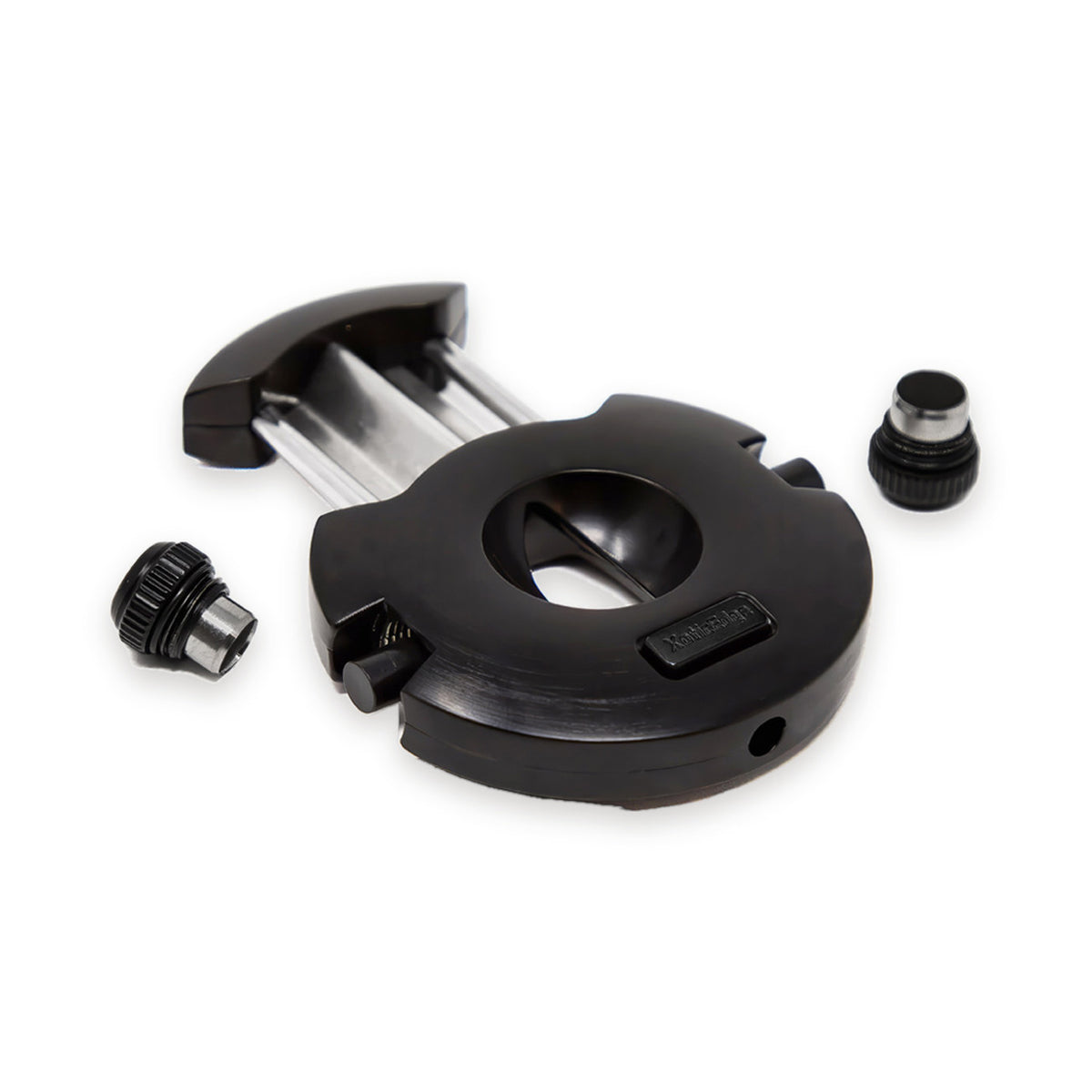 The Xceed cigar cutter shown disassembled, with the round black V-cut guillotine body and both the 8mm and 10mm screw-off bullet punches separated