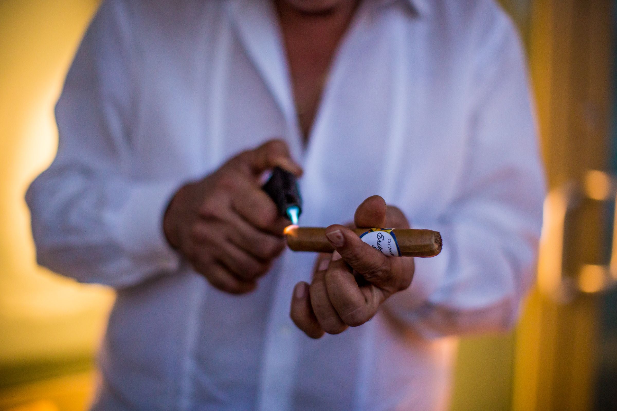 Lighting a fine cigar with a torch flame — the cigar ritual