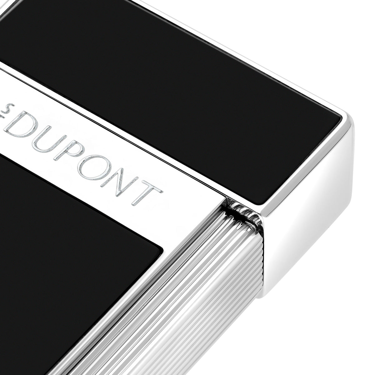 Close-up of the S.T. Dupont Biggy lighter in black lacquer, showing the engraved S.T. Dupont band and fluted chrome roller