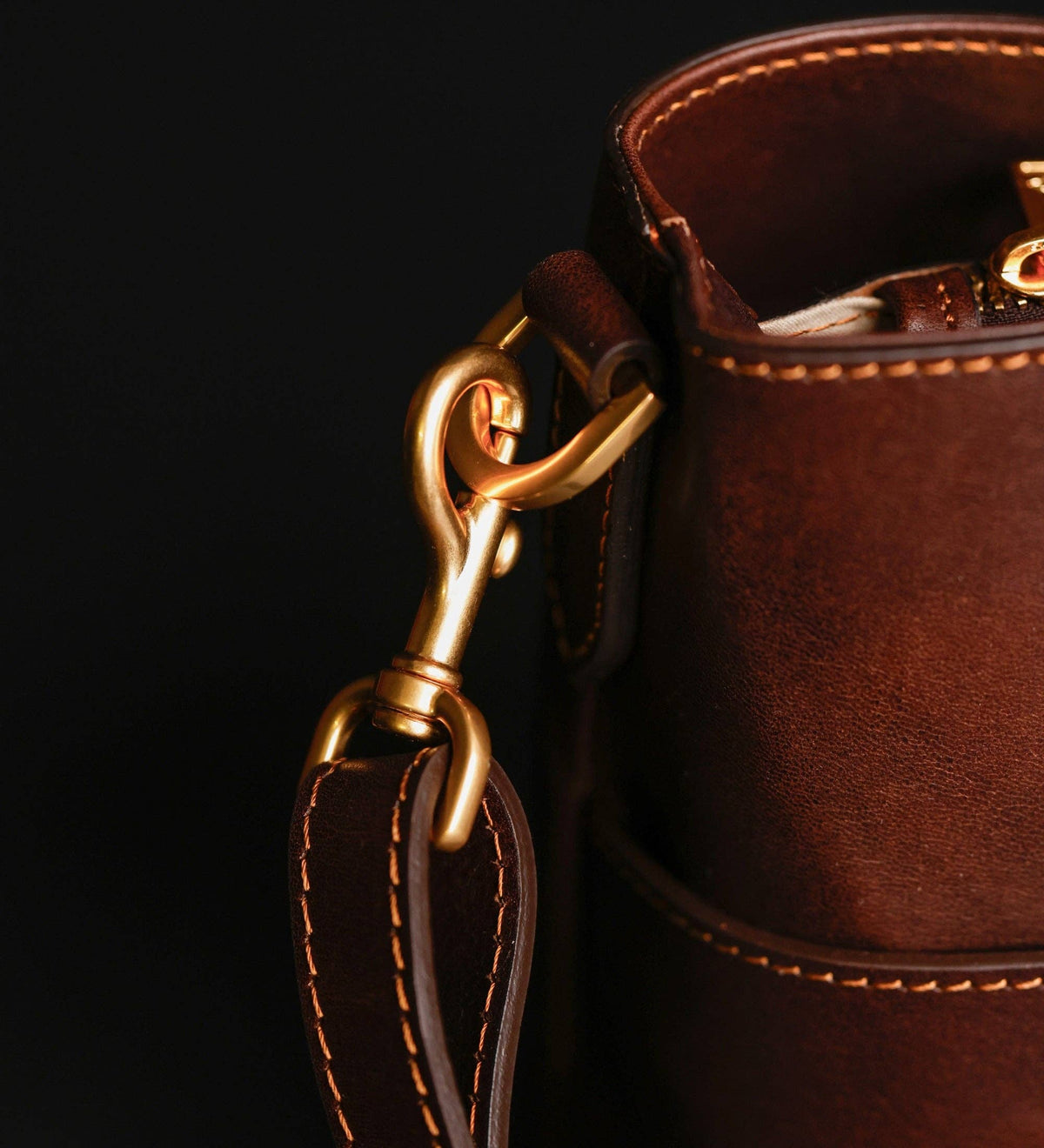 Camilla — close-up of the brass strap clip