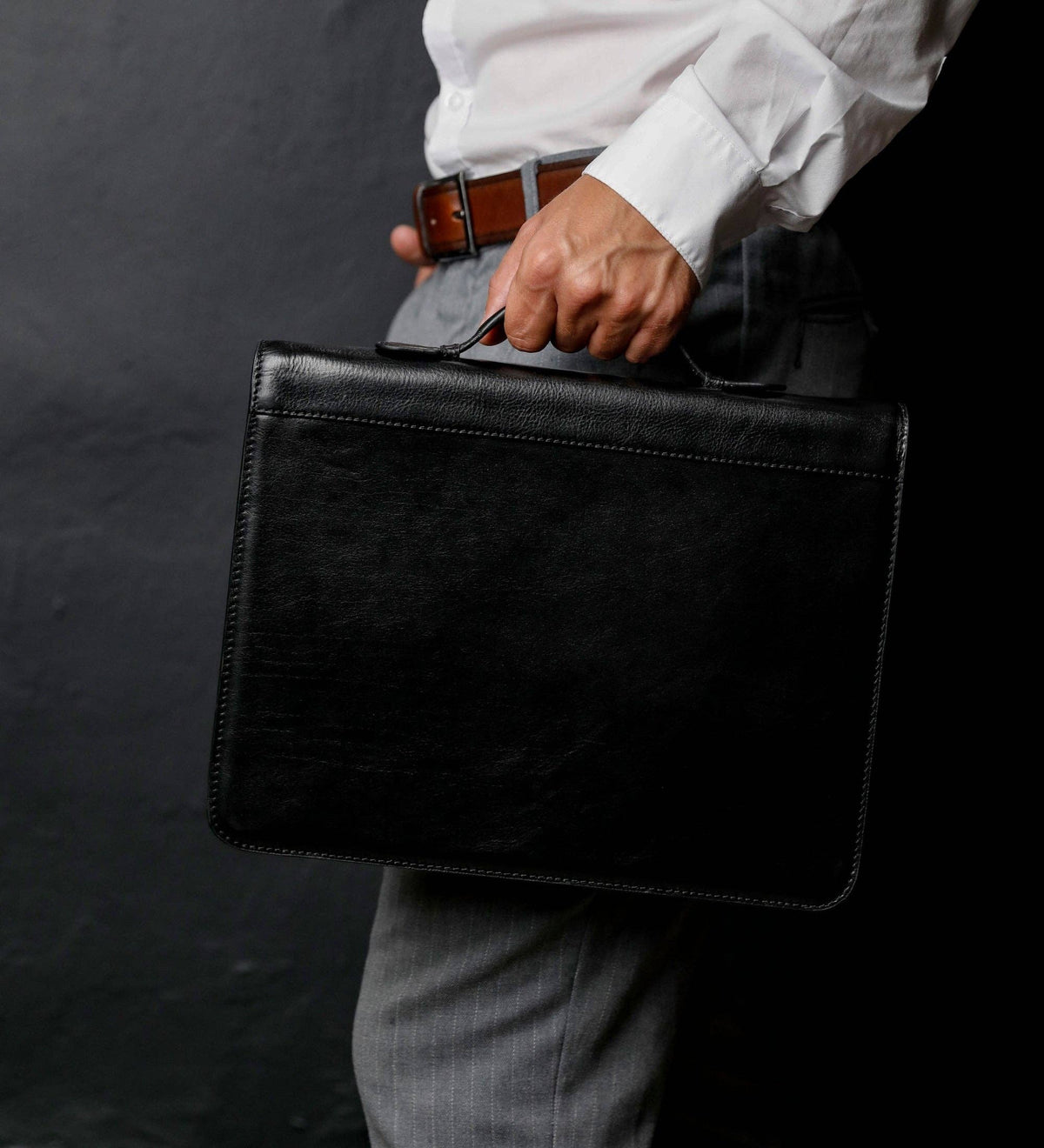 Joy in the Morning leather binder portfolio carried under the arm