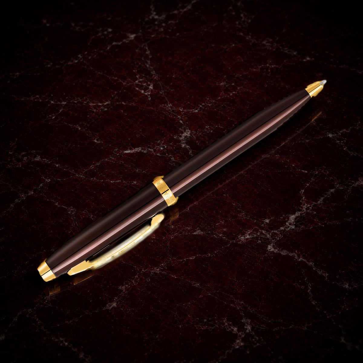 Sheaffer 100 Pen — Coffee Brown with Gold Trim: the ballpoint in coffee brown lacquer with PVD gold trim, on garnet marble
