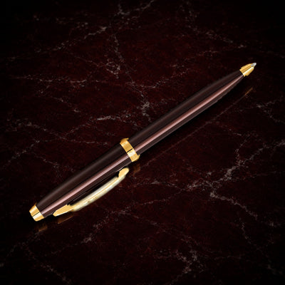 Sheaffer 100 Pen — Coffee Brown with Gold Trim: the ballpoint in coffee brown lacquer with PVD gold trim, on garnet marble
