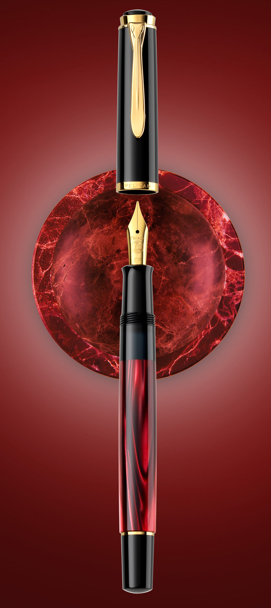 Pelikan M200 fountain pen in red marbled resin with gold trim, shown upright and uncapped against a round red marble panel