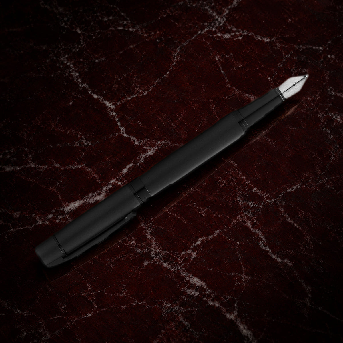 Sheaffer 300 Pen — Matte Black with Black Trim: the fountain pen in matte black lacquer with polished black trim, on garnet marble