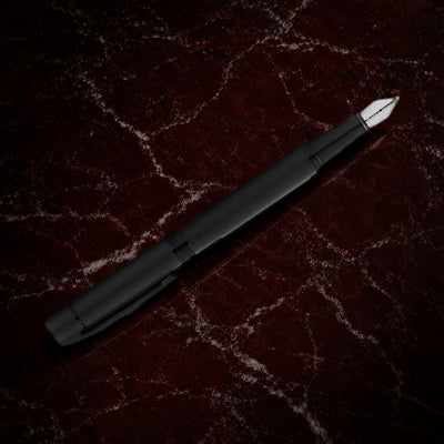 Sheaffer 300 Pen — Matte Black with Black Trim: the fountain pen in matte black lacquer with polished black trim, on garnet marble