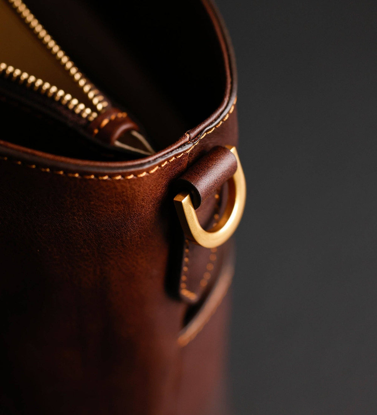Camilla — close-up of the brass zip pull