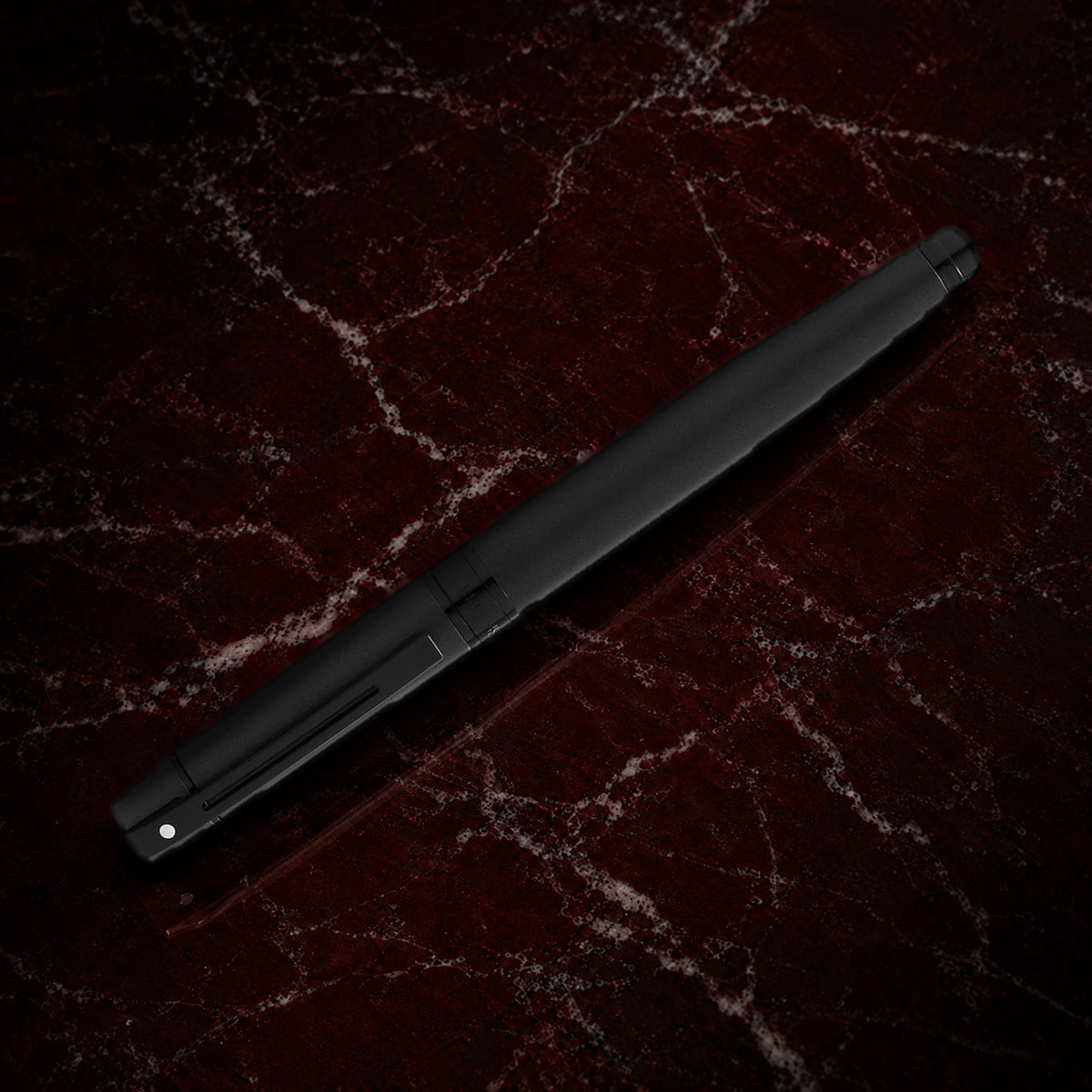 Sheaffer 300 Pen — Matte Black with Black Trim: the rollerball in matte black lacquer with polished black trim, on garnet marble
