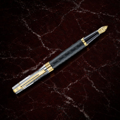 Sheaffer 300 Pen — Engraved Matte Black with Chrome Cap: the fountain pen with an engraved matte black barrel, chrome cap and PVD gold trim, on garnet marble