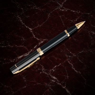 Sheaffer 300 Pen — Glossy Black with Gold Trim: the rollerball in glossy black lacquer with gold-tone trim, on garnet marble