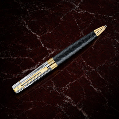 Sheaffer 300 Pen — Engraved Matte Black with Chrome Cap: the ballpoint with an engraved matte black barrel, chrome cap and PVD gold trim, on garnet marble