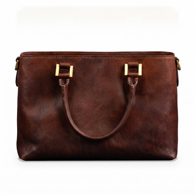 Camilla — Women's Leather Shoulder Bag in cognac brown Italian Vachetta, front view with the handle down, on a white background