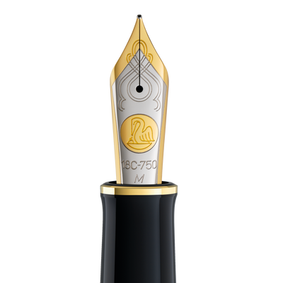 Close-up of the Pelikan Souverän M1000 two-tone 18-carat gold nib, engraved with the pelican emblem and marked 18C-750 M for the Medium width