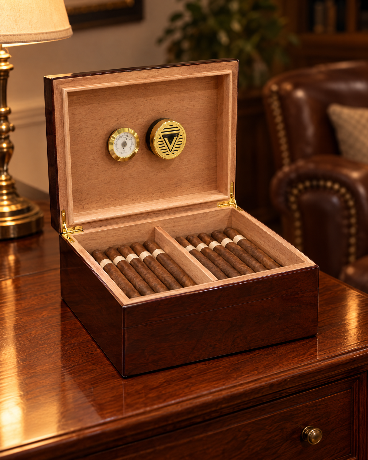 The Bellevue humidor in cherry finish open on a den sideboard, brass-rimmed hygrometer and humidifier in the lid