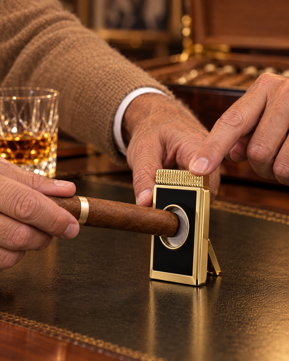 S.T. Dupont Cigar Cutter Stand — Black & Gold, a cigar cap seated in its aperture, a finger on the knurled top about to make the cut