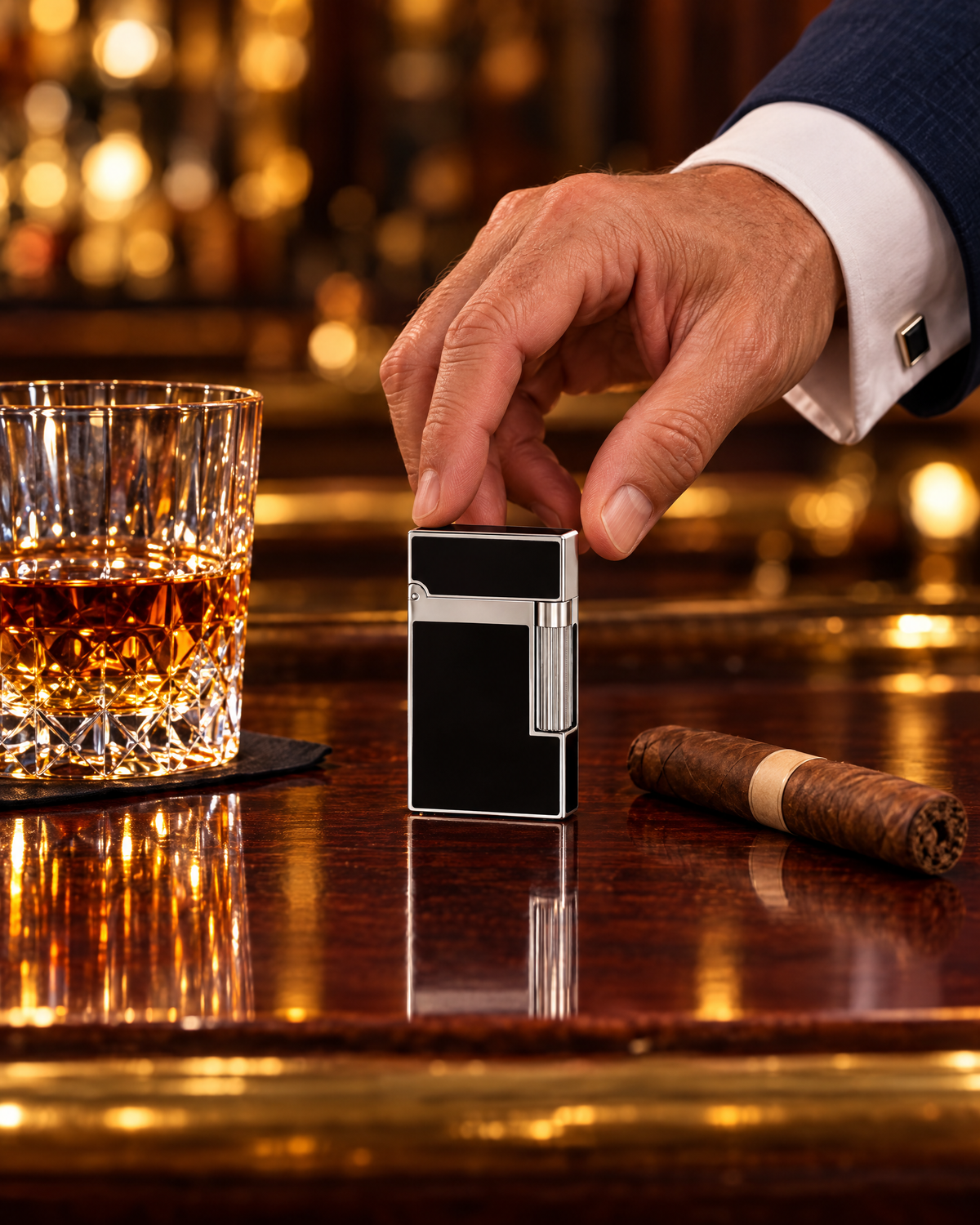 S.T. Dupont Ligne 2 Lighter — Black Lacquer & Palladium, standing on a mahogany bar beside a tumbler of bourbon and a cigar