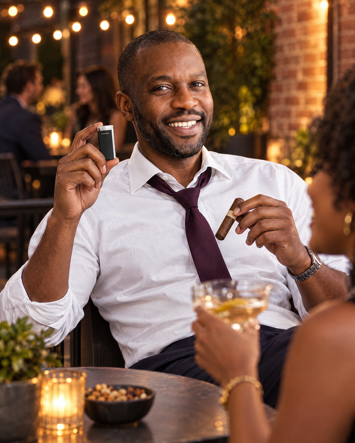 S.T. Dupont Minijet Lighter — Matte Black & Palladium, held up by a laughing litigator on a cocktail-bar patio at dusk