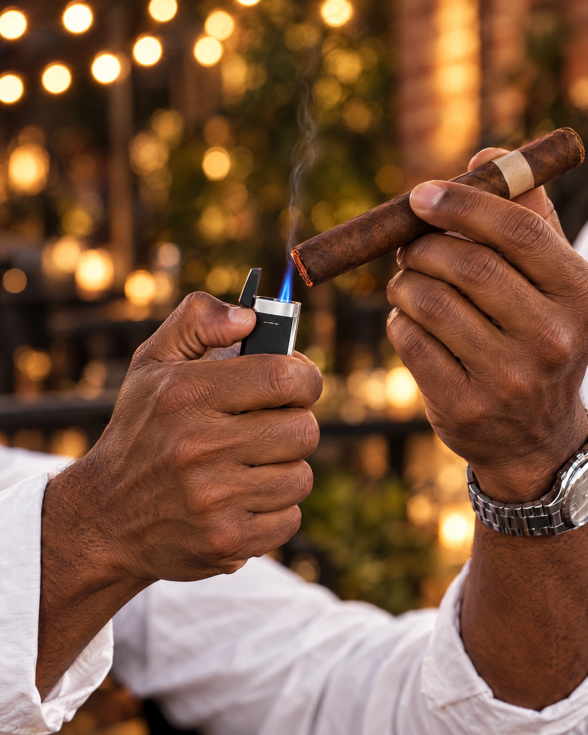 S.T. Dupont Minijet Lighter — Matte Black & Palladium, torch flame toasting a cigar under string lights at dusk