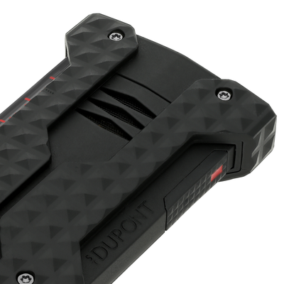 Close-up of the S.T. Dupont Windproof lighter in black, showing the recessed burner vents and corner bumpers