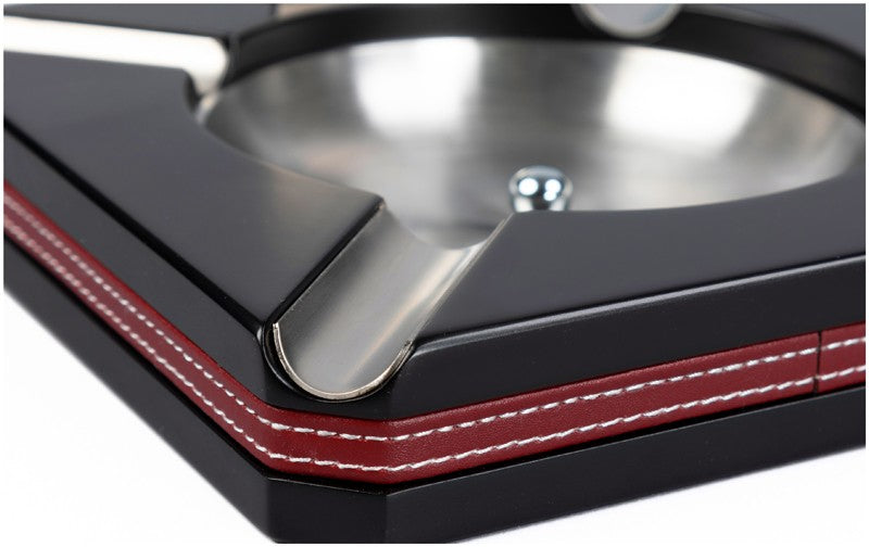 Leather-trim cigar ashtray, corner detail of the black leather and red stitching