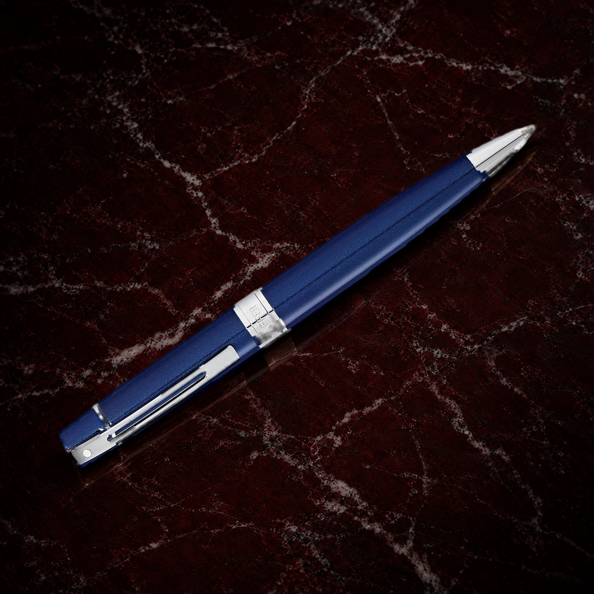 Sheaffer 300 Pen — Glossy Blue with Chrome Trim: the ballpoint in glossy blue lacquer with polished chrome trim, on garnet marble