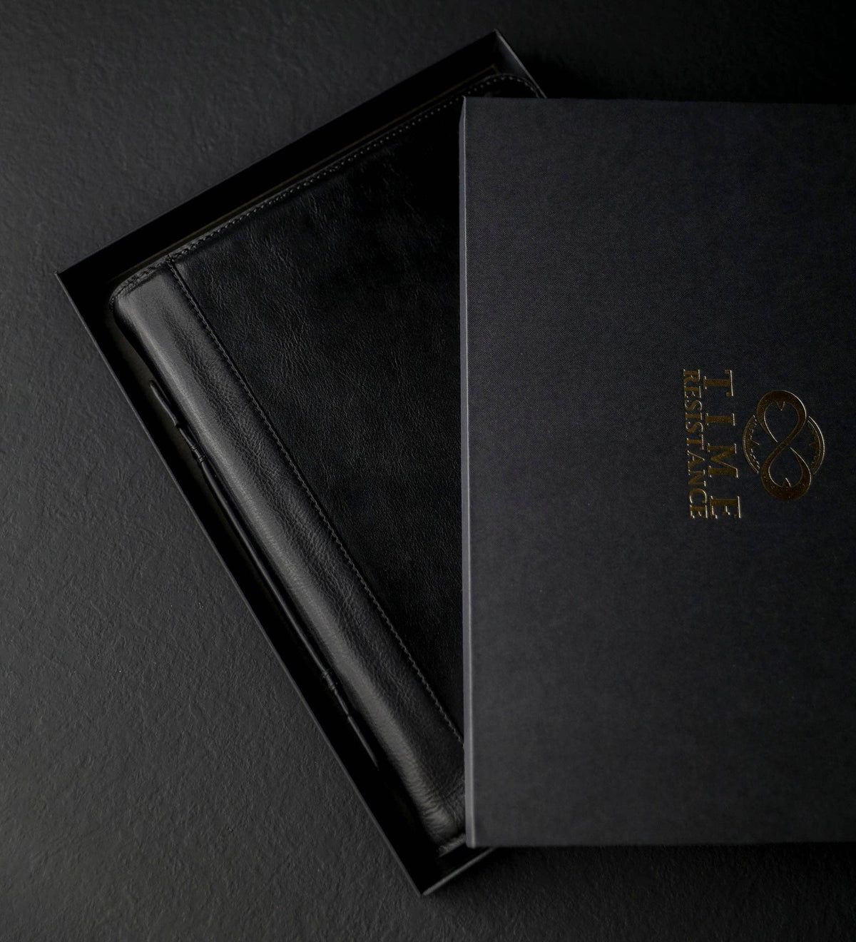 Joy in the Morning — close-up of the gold-embossed detail on black leather