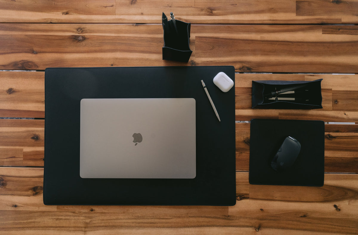 Carter Leather Desk Pad in black with desk accessories — lifestyle